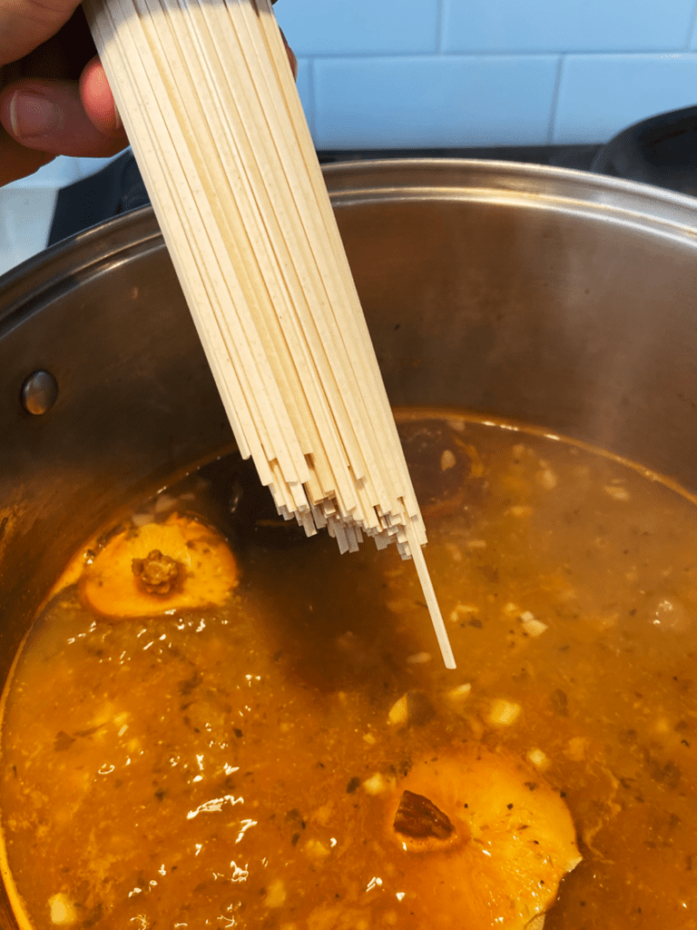 adding noodles to miso broth