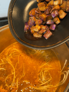 adding eggplant to soup