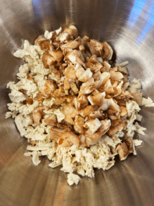 onions, shredded tofu, and mushrooms in a mixing bowl