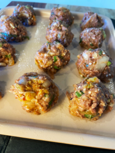 air fryer kimchi beyond meatballs rolled on a tray before cooking