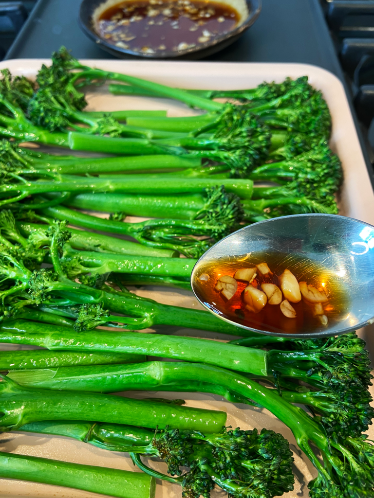 adding garlic soy sauce to tenderstem broccoli