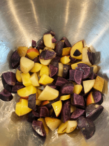 potatoes in a bowl with olive oil