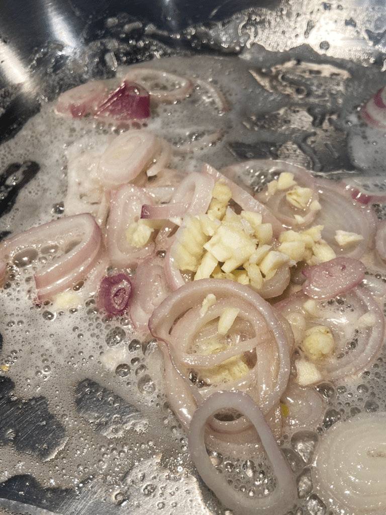 Adding garlic to pan for vegan guinness beyond steak tips