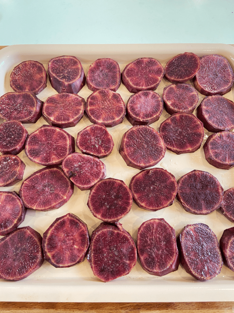 purple sweet potatoes on an air fryer tray