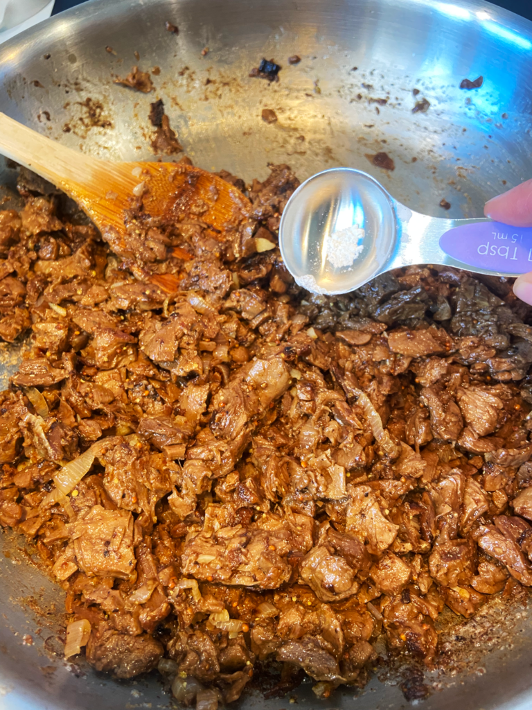 adding seasoning to Beyond steak tips