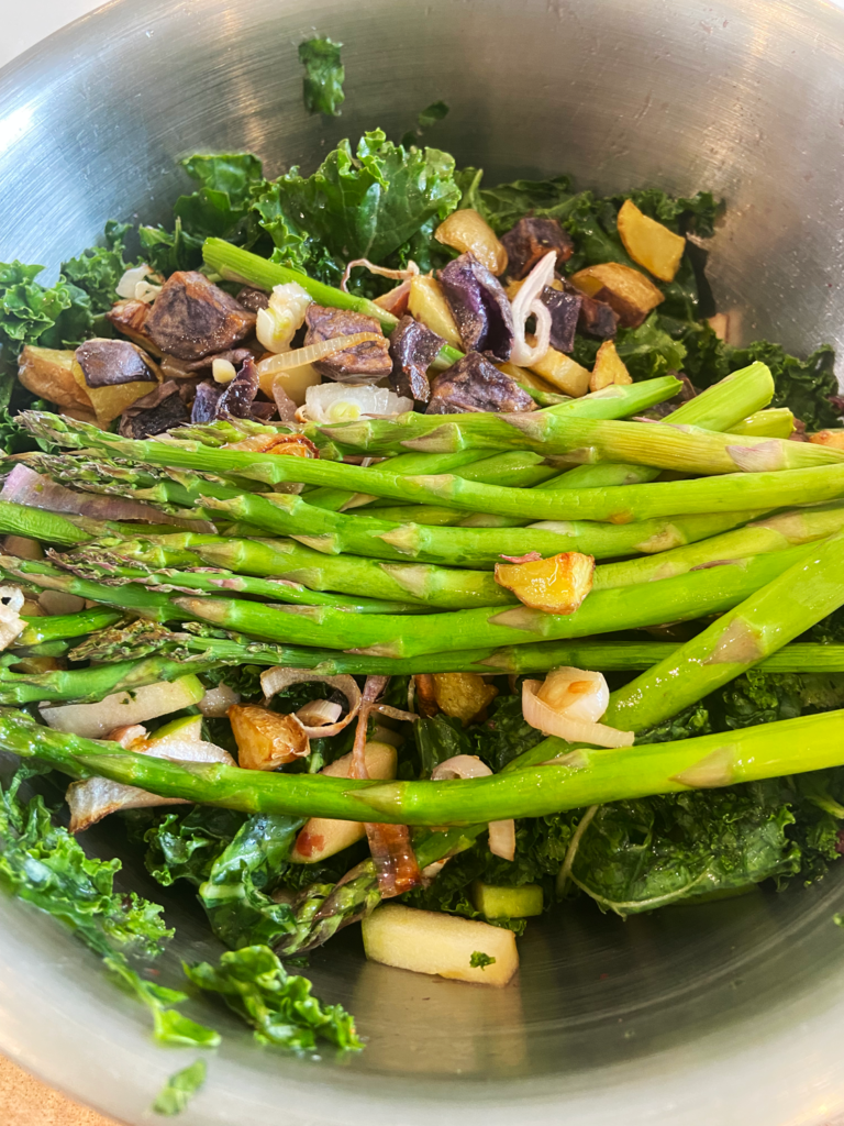 brunch kale and asparagus salad in mixing bowl