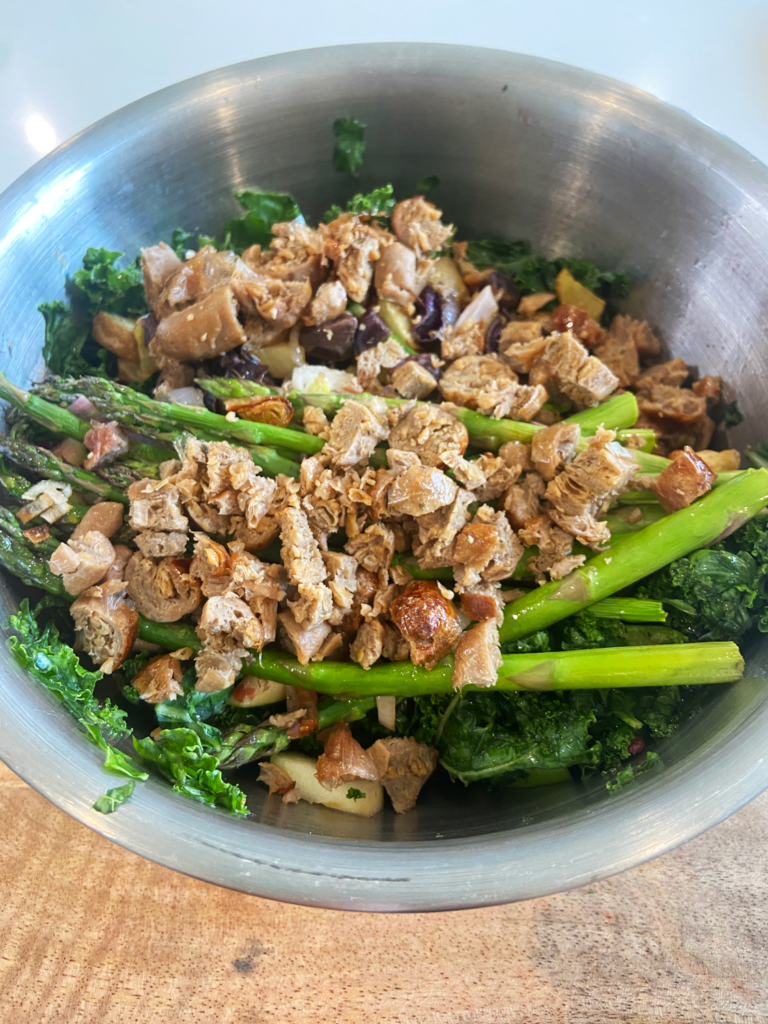 brunch kale and asparagus salad in mixing bowl