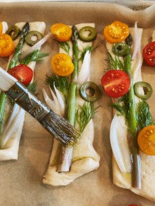 putting oil on Garden breadsticks before cooking