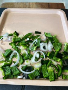 shallots and poblano peppers on a tray