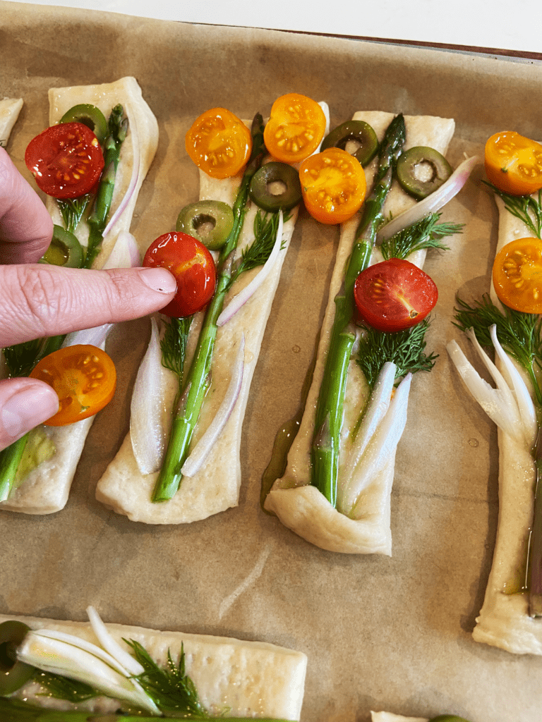 pressing toppings into garden breadsticks 