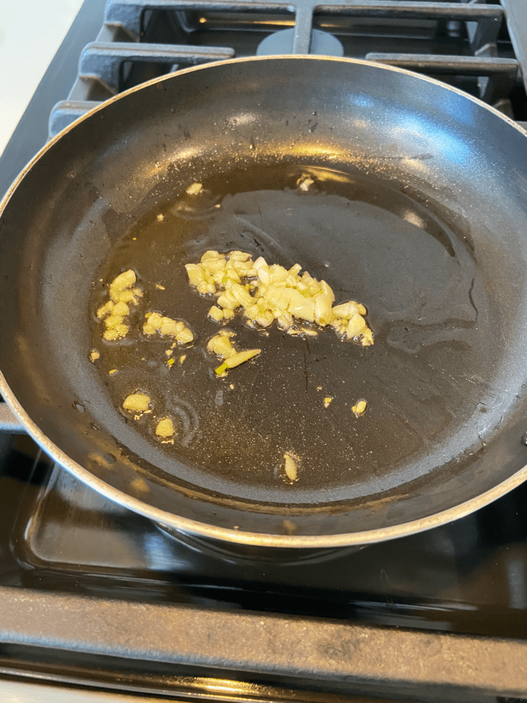 cooking garlic in a pan with oil