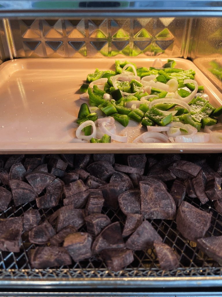 potatoes and veggies cooking in air fryer