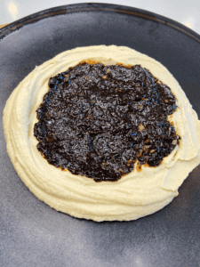 black garlic dip and hummus on plate