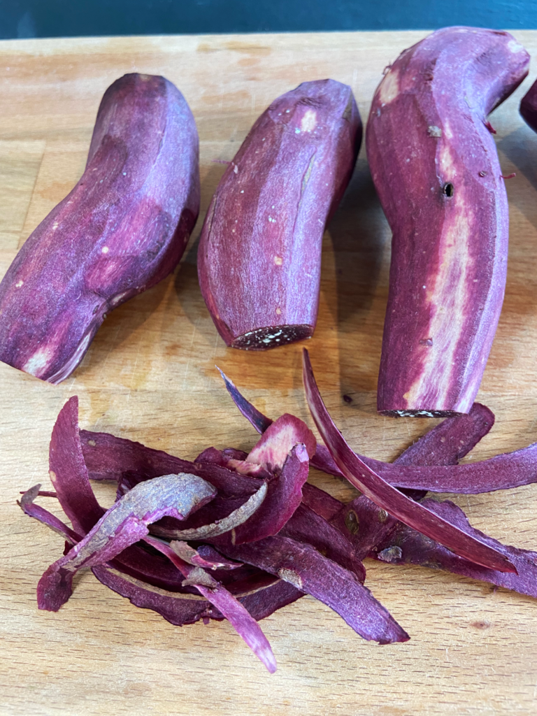 Peeling purple sweet potatoes for breakfast air fryer purple potatoes