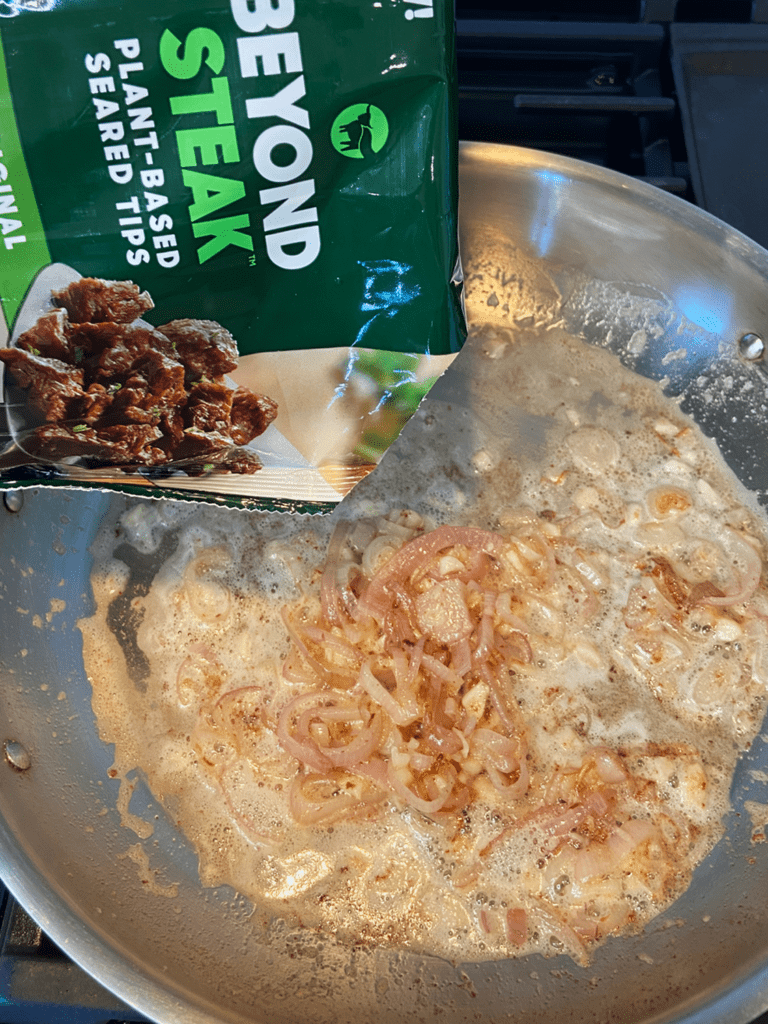 Adding vegan Beyond steak to skillet for vegan guinness beyond steak tips