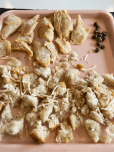 vegan chicken, capers, and bread on a tray