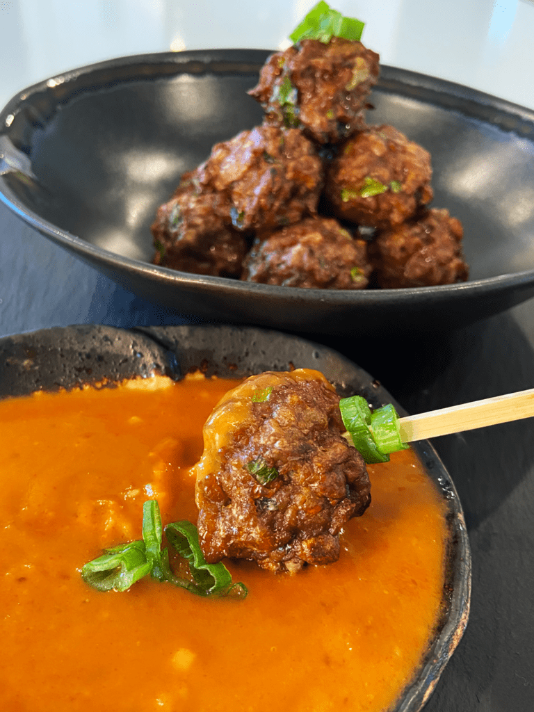 vegan meatballs in peanut sauce with vegan meat substitutes 