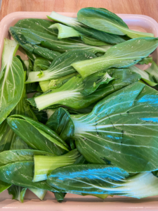 bok choy leaves on an air fryer tray