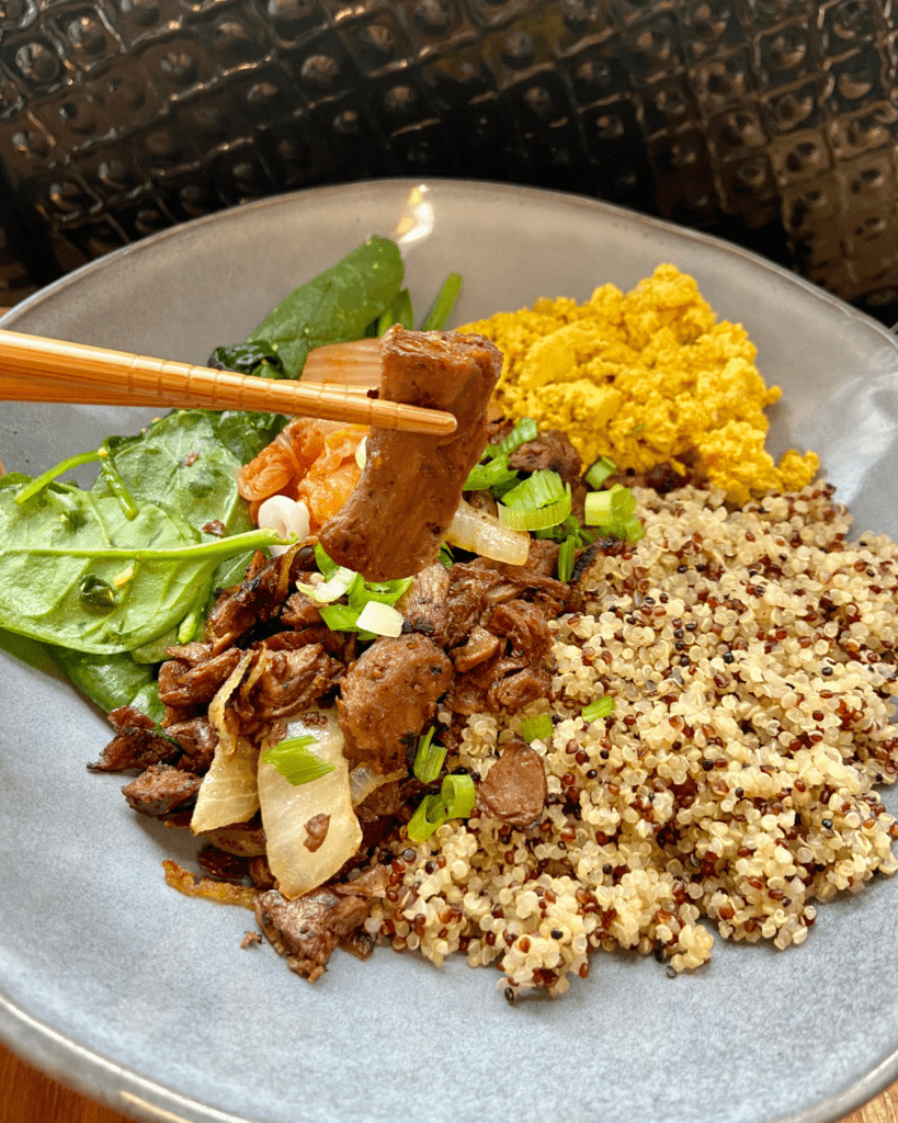 vegan steak and eggs bowl with vegan meat substitutes 