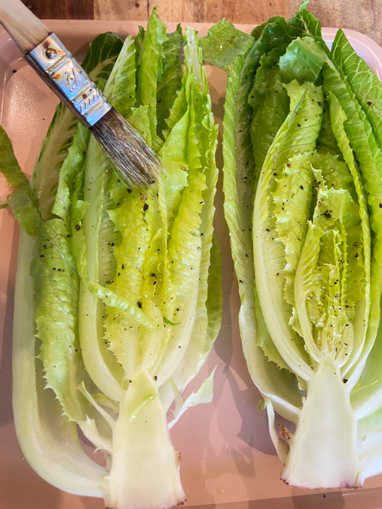 brushing olive oil on romaine lettuce