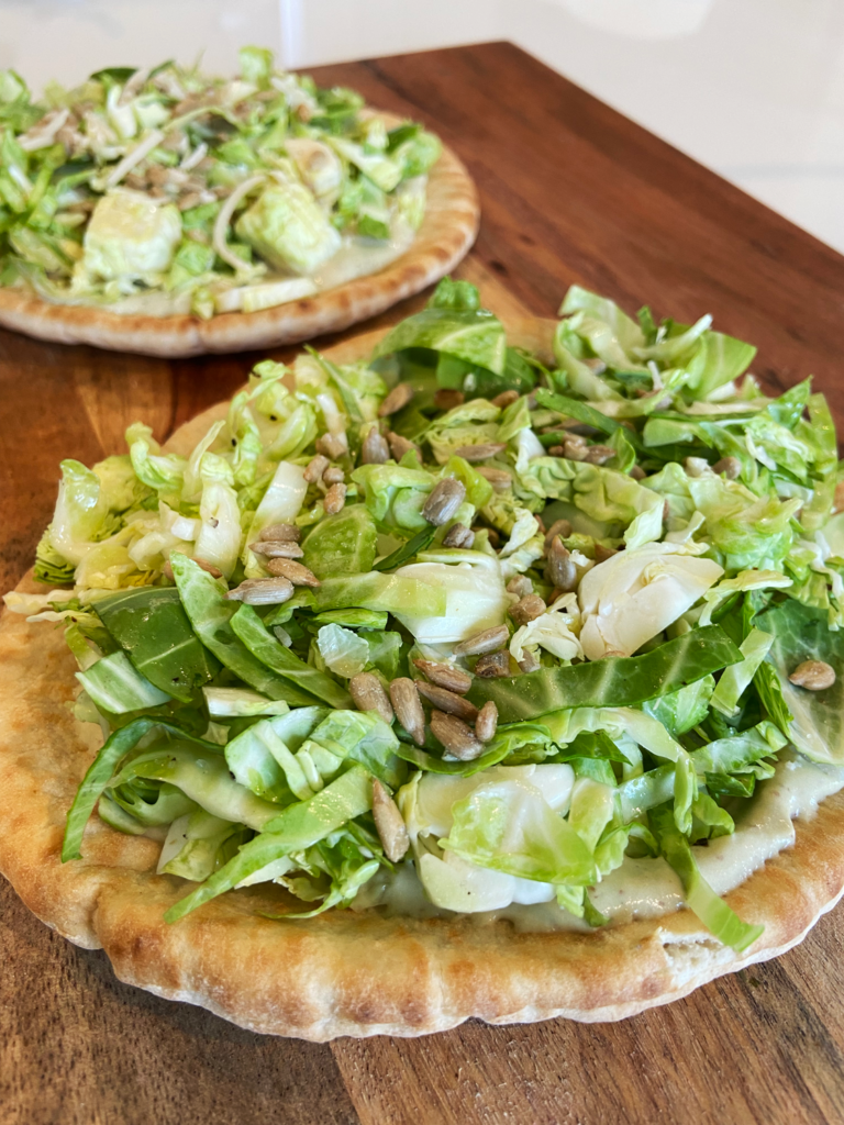 vegan brussels sprouts caesar pita pizza before baking