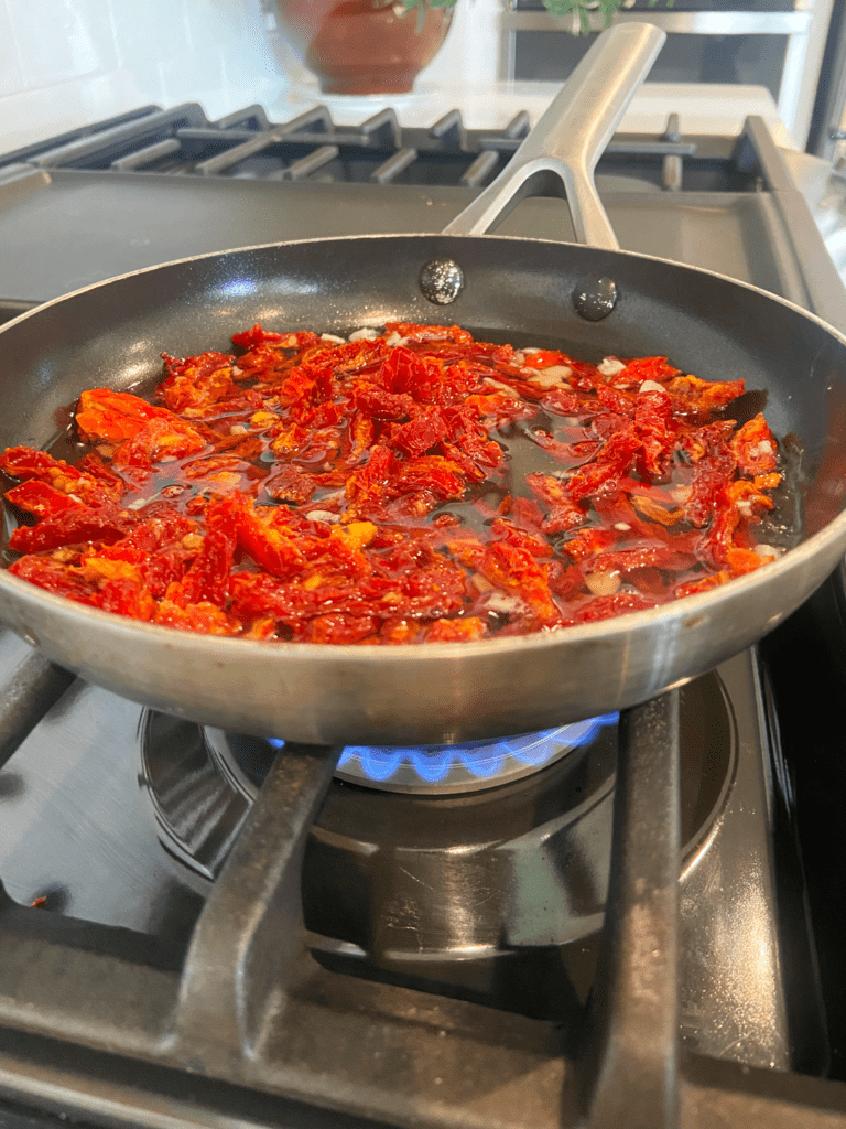 vodka infused sun-dried tomatoes cooking on stove